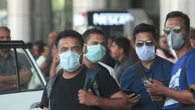 Passengers in face masks to protect against coronavirus, at Sanganer Airport, in Jaipur, Rajasthan, India, on Wednesday, March 11, 2020.(Himanshu Vyas / Hindustan Times)
