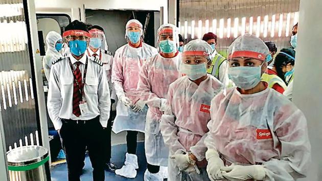 Wearing PPE suits, SpiceJet flight attendants gear up for departure of a New Delhi-bound flight at Raja Bhoj Airport in Bhopal on Monday.(ANI)