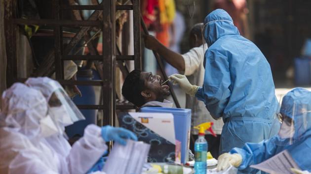 A doctor takes a swab sample of a resident at a COVID-19 coronavirus testing drive inside the Dharavi slums during a government-imposed nationwide lockdown in Mumbai, India, on Wednesday, May 20, 2020.(Pratik Chorge/HT Photo) A doctor takes a swab sample of a resident at a COVID-19 coronavirus testing drive inside the Dharavi slums during a government-imposed nationwide lockdown in Mumbai, India, on Wednesday, May 20, 2020.(Pratik Chorge/HT Photo)