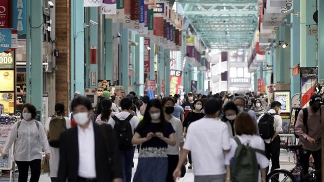 Pedestrians wearing protective masks walk through a shopping arcade in Tokyo’s Kichijoji area on May 26. Prime Minister Abe told a news conference on May 25 that reviving an economy mired in a recession was now the top priority. The country has reported 16,581 infections as of May 26 according to the worldometers coronavirus tracker. (Kiyoshi Ota / Bloomberg) Pedestrians wearing protective masks walk through a shopping arcade in Tokyo’s Kichijoji area on May 26. Prime Minister Abe told a news conference on May 25 that reviving an economy mired in a recession was now the top priority. The country has reported 16,581 infections as of May 26 according to the worldometers coronavirus tracker. (Kiyoshi Ota / Bloomberg)