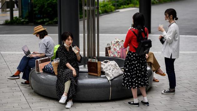 People gathered outside Futako-Tamagawa train station in Tokyo on May 26. Tokyo residents took to the streets with a mixture of relief and trepidation as they prepared for a new normal of living with the novel coronavirus. (Behrouz Mehri / AFP) People gathered outside Futako-Tamagawa train station in Tokyo on May 26. Tokyo residents took to the streets with a mixture of relief and trepidation as they prepared for a new normal of living with the novel coronavirus. (Behrouz Mehri / AFP)