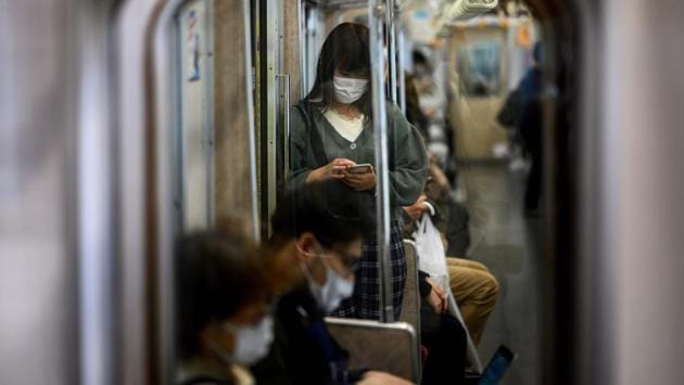 Morning commutes resumed in Tokyo, albeit with face masks and social distancing. Several companies told news agency Reuters they would let large portions of their staff continue working from home, while railway operator Odakyu Electric Railway has said it will release usage data to help passengers avoid crowded trains. (Behrouz Mehri / AFP) Morning commutes resumed in Tokyo, albeit with face masks and social distancing. Several companies told news agency Reuters they would let large portions of their staff continue working from home, while railway operator Odakyu Electric Railway has said it will release usage data to help passengers avoid crowded trains. (Behrouz Mehri / AFP)
