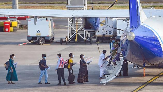 Passengers stand in a queue to board an Indigo plane for domestic travel, after flights resumed during the ongoing nationwide lockdown, at Chennai airport. (PTI) Passengers stand in a queue to board an Indigo plane for domestic travel, after flights resumed during the ongoing nationwide lockdown, at Chennai airport. (PTI)
