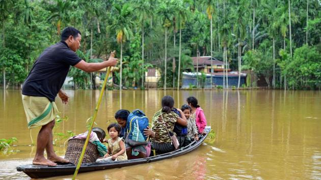 Villagers use a country boat to shift from a flooded locality following heavy rainfall at Bolbola in Goalapara district of Assam on May 25. The highest flood level for the Brahmaputra in the Jorhat stretch is 87.37 metres and the current level is 85.78 metres. In Jiabharali, the highest flood level is 78.5 metres and the current level is 77.36 metres, as reported by HT on May 26. (PTI)