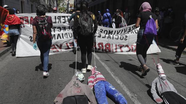Protesters drag effigies of Finance Minister Richard Martinez, President Lenin Moreno and the Minister of Interior Maria Paula Romo during the protest. Worker unions said the government reforms include shortening workdays from 8 to 6 hours, thus lowering pay, and criticized that the new laws benefit employers over workers. (Dolores Ochoa / AP) Protesters drag effigies of Finance Minister Richard Martinez, President Lenin Moreno and the Minister of Interior Maria Paula Romo during the protest. Worker unions said the government reforms include shortening workdays from 8 to 6 hours, thus lowering pay, and criticized that the new laws benefit employers over workers. (Dolores Ochoa / AP)