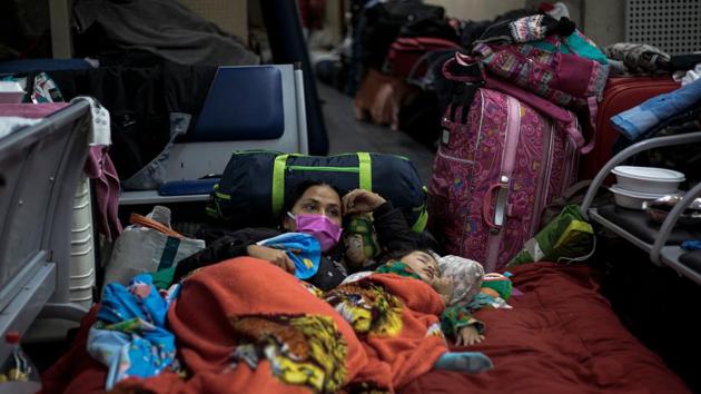 A stranded Colombian citizen looks on while a child wrapped in a blanket sleeps besides her at the airport. “The only thing we’re asking for is help from our government. We’re Colombians,” Astrid Serna, one woman told AP. “They need to understand that if we had money, we wouldn’t be here.” (Miguel Schincariol / AFP) A stranded Colombian citizen looks on while a child wrapped in a blanket sleeps besides her at the airport. “The only thing we’re asking for is help from our government. We’re Colombians,” Astrid Serna, one woman told AP. “They need to understand that if we had money, we wouldn’t be here.” (Miguel Schincariol / AFP)