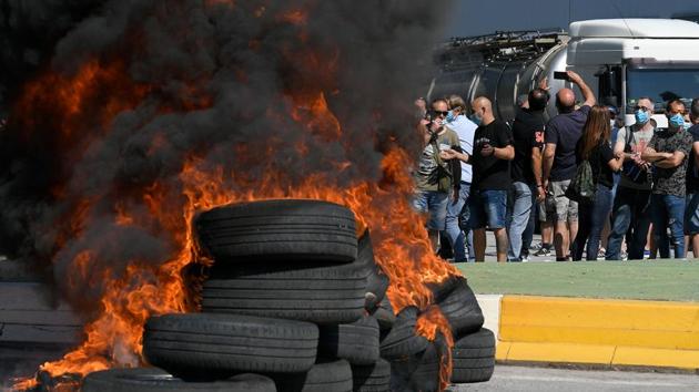 “We are going to keep our fight, putting in check governments and asking them to support us in reverting this decision,” Juan Carlos Vicente, head of the workers’ committee was reported by AP to have told a crowd that quickly moved to put fire to a pile of tires. (Lluis Gene / AFP) “We are going to keep our fight, putting in check governments and asking them to support us in reverting this decision,” Juan Carlos Vicente, head of the workers’ committee was reported by AP to have told a crowd that quickly moved to put fire to a pile of tires. (Lluis Gene / AFP)