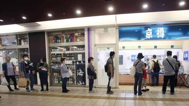 People wearing face masks to protect against the spread of the new coronavirus keep social distancing as they wait to buy sushi in Yokohama, near Tokyo, Thursday, May 28, 2020. (AP Photo/Koji Sasahara) (AP) People wearing face masks to protect against the spread of the new coronavirus keep social distancing as they wait to buy sushi in Yokohama, near Tokyo, Thursday, May 28, 2020. (AP Photo/Koji Sasahara) (AP)