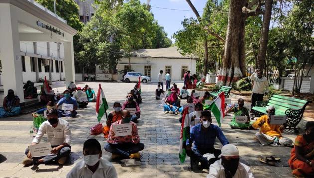 Tribals stage sit-in protest seeking new ration cards in Palghar.(HT Photo)