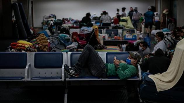 Stranded Colombian citizens camping at Guarulhos International Airport on May 26. More than 200 Colombian citizens remain stranded at the airport waiting for a humanitarian flight to take them home. (AFP) Stranded Colombian citizens camping at Guarulhos International Airport on May 26. More than 200 Colombian citizens remain stranded at the airport waiting for a humanitarian flight to take them home. (AFP)