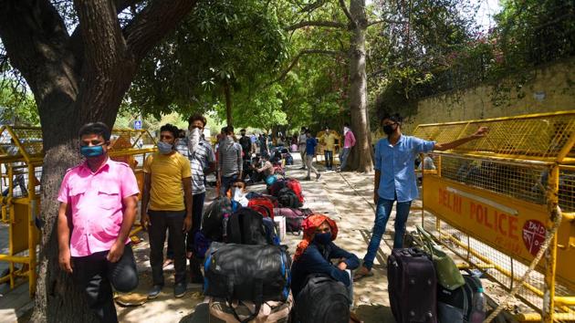 Migrants wait to get screened and register for transit buses that will ferry them to railway stations for Shramik Special trains, at Vasant Kunj in New Delhi. (Amal KS/ Hindustan Times) Migrants wait to get screened and register for transit buses that will ferry them to railway stations for Shramik Special trains, at Vasant Kunj in New Delhi. (Amal KS/ Hindustan Times)