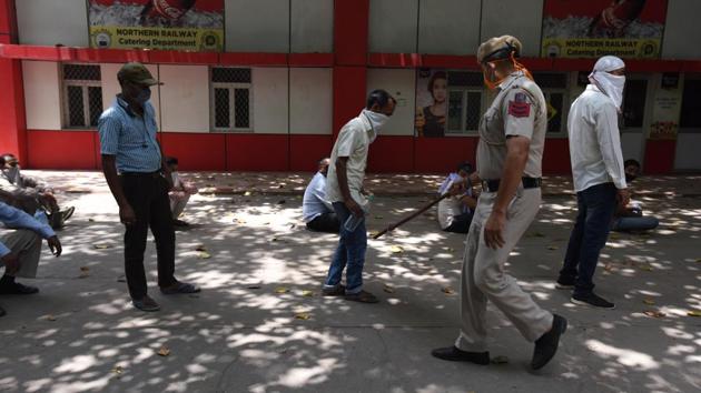 A police personnel ensures social distancing as people wait to reach the front of the queue at a ticketing counter at NDLS. Tickets that are being booked at the counters are for journeys beginning June 1—when 100 pairs of trains will begin service from Delhi stations. People can cancel all tickets booked before and during the lockdown. (Raj K Raj / HT Photo)