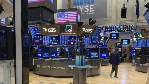 A trader walks across the partially reopened trading floor of the New York Stock Exchange on Thursday.(AP File Photo) A trader walks across the partially reopened trading floor of the New York Stock Exchange on Thursday.(AP File Photo)