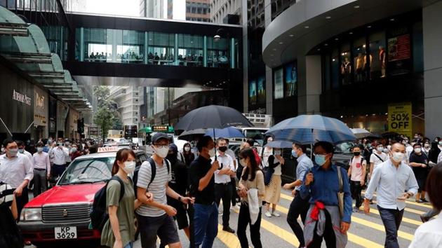 Anti-government demonstrators take part in a protest during a lunch time in Central, as a second reading of a controversial national anthem law takes place in Hong Kong, China.(REUTERS) Anti-government demonstrators take part in a protest during a lunch time in Central, as a second reading of a controversial national anthem law takes place in Hong Kong, China.(REUTERS)