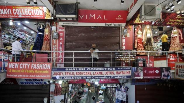 Shops open for business after relaxation in lockdown restrictions, at Sector 27 market, in Noida.(Sunil Ghosh / Hindustan Times)