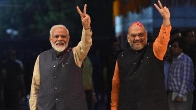 Prime Minister Narendra Modi (L) and president of the ruling Bharatiya Janata Party (BJP) Amit Shah gesture as they celebrate the victory in India's general elections, in New Delhi on May 23, 2019.(AFP) Prime Minister Narendra Modi (L) and president of the ruling Bharatiya Janata Party (BJP) Amit Shah gesture as they celebrate the victory in India's general elections, in New Delhi on May 23, 2019.(AFP)