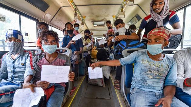 Migrants travelling to West Bengal show their medical certificates before boarding a bus to the railway station, during the ongoing nationwide lockdown, at Yamuna Sports Complex in New Delhi.(PTI) Migrants travelling to West Bengal show their medical certificates before boarding a bus to the railway station, during the ongoing nationwide lockdown, at Yamuna Sports Complex in New Delhi.(PTI)