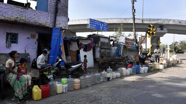 People wait in a queue to collect drinking water from a Delhi Jal Board tanker on a hot summer day in Geeta Colony, New Delhi on May 25. The daily wait for water trucks in the capital’s slum and settlements has become even worse since the pandemic hit the city with social distancing precautions stretching wait times. (Sonu Mehta / HT Photo) People wait in a queue to collect drinking water from a Delhi Jal Board tanker on a hot summer day in Geeta Colony, New Delhi on May 25. The daily wait for water trucks in the capital’s slum and settlements has become even worse since the pandemic hit the city with social distancing precautions stretching wait times. (Sonu Mehta / HT Photo)