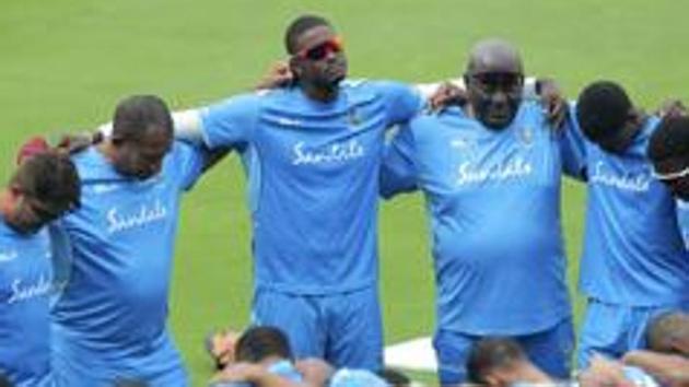 West Indies' Jason Holder, center, and team members huddle during a training session. (AP) West Indies' Jason Holder, center, and team members huddle during a training session. (AP)