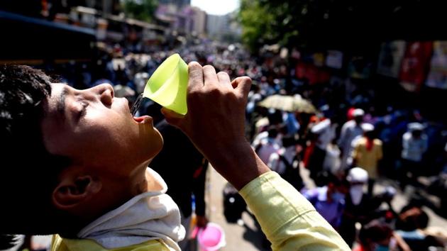 A migrant worker’s child drinks water on a hot afternoon while waiting for a transit bus from Dharavi in Mumbai on May 26. A sweltering summer and water supply surges natural to the summer months, have only aggravated the troubles of everyday Indians reeling under lockdown. (Satish Bate / HT Photo) A migrant worker’s child drinks water on a hot afternoon while waiting for a transit bus from Dharavi in Mumbai on May 26. A sweltering summer and water supply surges natural to the summer months, have only aggravated the troubles of everyday Indians reeling under lockdown. (Satish Bate / HT Photo)