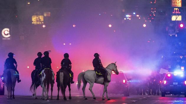 The Omaha police mounted patrol are silhouetted in tear gas as they approach protesters at 72nd and Dodge Streets on May 29. (Chris Machian / Omaha World-Herald via AP) The Omaha police mounted patrol are silhouetted in tear gas as they approach protesters at 72nd and Dodge Streets on May 29. (Chris Machian / Omaha World-Herald via AP)