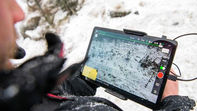 Neila Fjellstrom, a reindeer herder, monitors the location of his herd on a screen. Using a drone allows Fjellstrom and his wife to keep track of the animals when poor snowfall makes travel by snowmobile impossible. They also herd them on with recordings of his dog barking when reindeers head to areas with little food or hazards like roads or windfarms whose turbine noise scares the reindeer. (Jonathan Nackstrand / AFP) Neila Fjellstrom, a reindeer herder, monitors the location of his herd on a screen. Using a drone allows Fjellstrom and his wife to keep track of the animals when poor snowfall makes travel by snowmobile impossible. They also herd them on with recordings of his dog barking when reindeers head to areas with little food or hazards like roads or windfarms whose turbine noise scares the reindeer. (Jonathan Nackstrand / AFP)