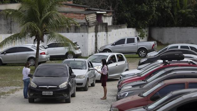 Couples wait inside their cars for their drive-thru weddings outside the registry office. Rio de Janeiro state is Brazil’s second hardest-hit state by the pandemic, with nearly 45,000 people infected, according to the official tally. Experts say that is a significant undercount due to lack of testing. There have been almost 5,000 deaths. (Silvia Izquierdo / AP)