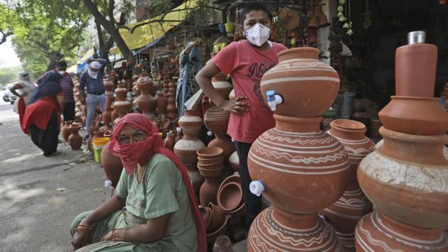 A woman waits for customers as she sells matkas or earthen pots, used to keep water cold during summers in New Delhi on May 28. Even before the coronavirus pandemic, water was in short supply for the estimated 100 million people living in India’s urban slums. Last year the southern city of Chennai ran out of water entirely. (Manish Swarup / AP) A woman waits for customers as she sells matkas or earthen pots, used to keep water cold during summers in New Delhi on May 28. Even before the coronavirus pandemic, water was in short supply for the estimated 100 million people living in India’s urban slums. Last year the southern city of Chennai ran out of water entirely. (Manish Swarup / AP)