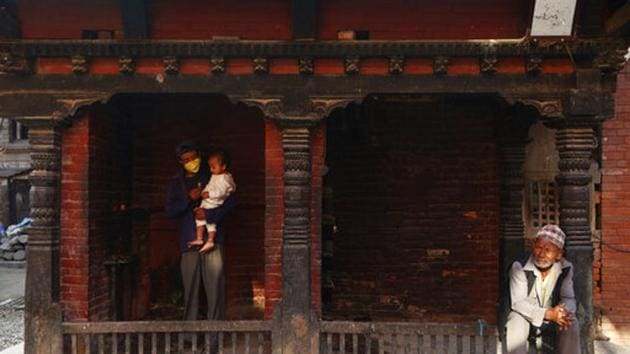 A Nepalese man gives blessed flower to his child at a small temple in Bhaktapur, Nepal. Image used for representational purpose only. (AP) A Nepalese man gives blessed flower to his child at a small temple in Bhaktapur, Nepal. Image used for representational purpose only. (AP)