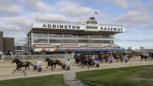 Horses along with their trainers race past a pavilion stand during race five at the Addington Raceway in Christchurch, New Zealand. New Zealand’s financially troubled horse racing industry reopened on May 28 after being shuttered for months because of the coronavirus (COVID-19) outbreak, leading the return of organised sports as the nation moves toward normalcy. (Mark Baker / AP)