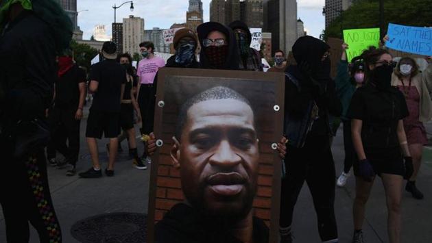 A protestor holds a photo of George Floyd during a protest against his death in Minneapolis police custody, and the assault of Sha'Teina and Dan Grady El by Washtenaw County police, in Detroit, Michigan on May 29. (Sylvia Jarrus / REUTERS) A protestor holds a photo of George Floyd during a protest against his death in Minneapolis police custody, and the assault of Sha'Teina and Dan Grady El by Washtenaw County police, in Detroit, Michigan on May 29. (Sylvia Jarrus / REUTERS)