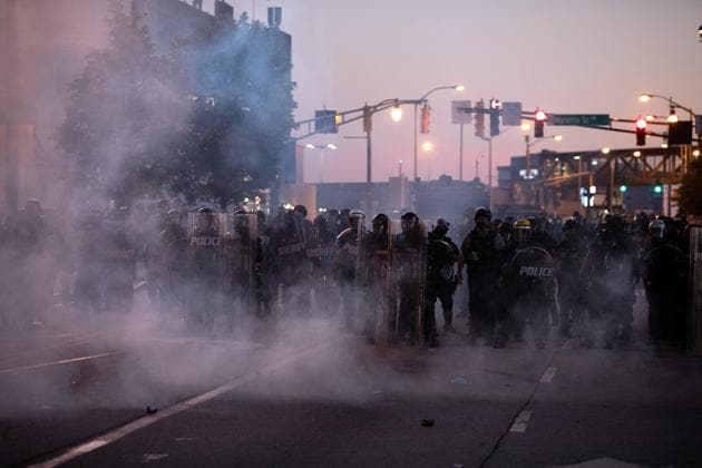 A cloud of tear gas thrown by police hangs in the air near police in riot gear near in Downtown Atlanta, during a protest against the death in Minneapolis police custody of African-American man George Floyd, in Atlanta, Georgia.(REUTERS) A cloud of tear gas thrown by police hangs in the air near police in riot gear near in Downtown Atlanta, during a protest against the death in Minneapolis police custody of African-American man George Floyd, in Atlanta, Georgia.(REUTERS)