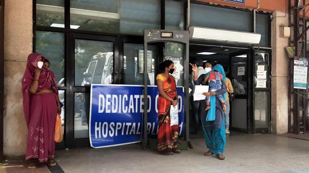 Visitors interact with each other outside the Ram Manohar Lohia (RML) hospital’s Covid Block-1. Covid patients opting for the hotel facility will have to pay a minimum of ₹63,000 for a 3-4 star hotel for a week’s stay, which is the period mandated for patients with mild symptoms. In addition, if the patient needs oxygen support, ₹2,000 will be charged on a daily basis. (Sonu Mehta / HT Photo)