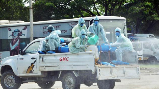 Health workers in PPE kits sanitizing the street around Sarusajai Quarantine centre in Guwahati on Sunday.(ANI)