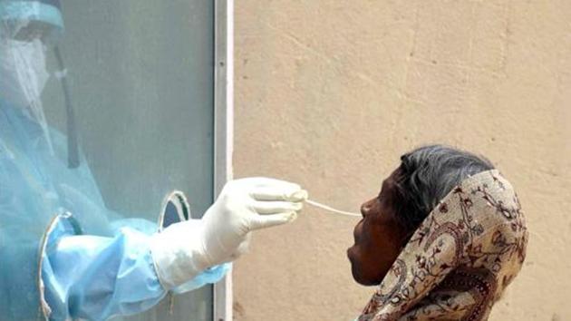 Medical workers wear protective suit and collect swab samples from people for Covid-19 testing in Ranchi on Saturday.(ANI Photo)