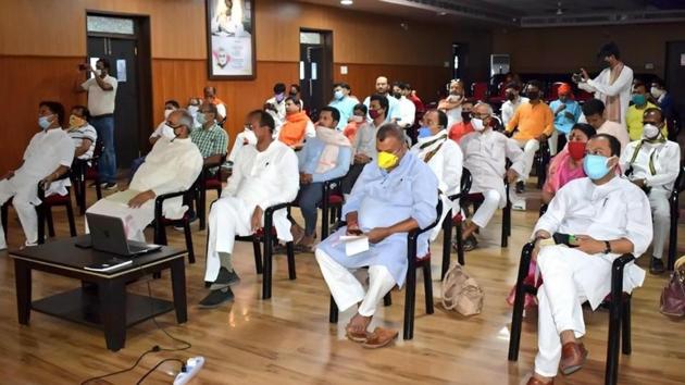 Bharatiya Janata Party (BJP) party leaders listening to Prime Minister Narendra Modi's Mann Ki Baat at the party’s office in Patna on Sunday.(Santosh Kumar/HT PHOTO)