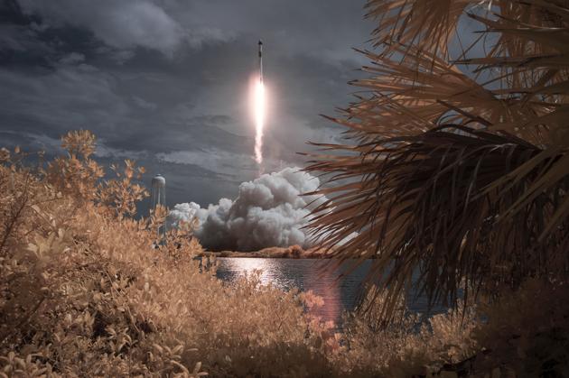 In this photo provided by NASA, a SpaceX Falcon 9 rocket carrying the company's Crew Dragon spacecraft is seen in this false color infrared exposure as it is launched on NASA's SpaceX Demo-2 mission to the International Space Station with NASA astronauts Robert Behnken and Douglas Hurley onboard.(AP) In this photo provided by NASA, a SpaceX Falcon 9 rocket carrying the company's Crew Dragon spacecraft is seen in this false color infrared exposure as it is launched on NASA's SpaceX Demo-2 mission to the International Space Station with NASA astronauts Robert Behnken and Douglas Hurley onboard.(AP)