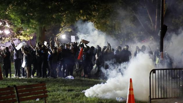Tear gas billows as demonstrators gather in Lafayette Park to protest the death of George Floyd, Sunday, May 31, 2020, near the White House in Washington. Floyd died after being restrained by Minneapolis police officers (AP Photo/Alex Brandon)(AP) Tear gas billows as demonstrators gather in Lafayette Park to protest the death of George Floyd, Sunday, May 31, 2020, near the White House in Washington. Floyd died after being restrained by Minneapolis police officers (AP Photo/Alex Brandon)(AP)