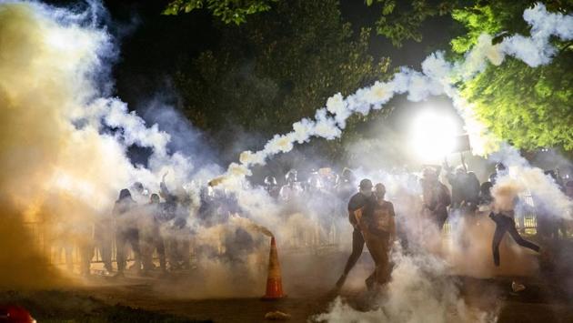 Tear gas rises as protesters face off with the police during a demonstration outside the White House over the death of George Floyd at the hands of Minneapolis Police in Washington, DC on May 31. Secret Service agents rushed President Donald Trump to a White House bunker on Friday night as hundreds of protesters gathered outside the executive mansion, some of them throwing rocks and tugging at police barricades. (Samuel Corum / AFP)