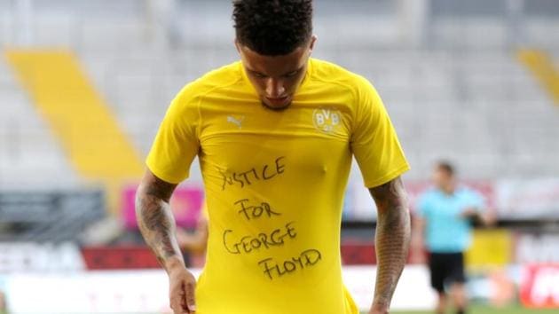 Borussia Dortmund's Jadon Sancho celebrates scoring their second goal with a 'Justice for George Floyd' shirt.(Reuters)