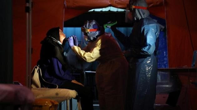 Health workers get a swab from a woman in a makeshift centre tent set up in the Kuala Lumpur Hospital parking lot, amid the coronavirus disease (COVID-19) outbreak, in Kuala Lumpur. (Representational Image) (Reuters) Health workers get a swab from a woman in a makeshift centre tent set up in the Kuala Lumpur Hospital parking lot, amid the coronavirus disease (COVID-19) outbreak, in Kuala Lumpur. (Representational Image) (Reuters)