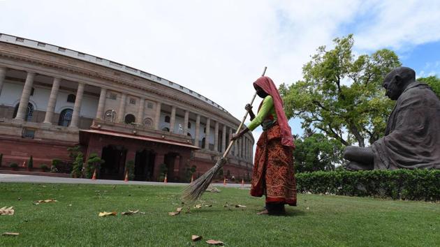 A worker cleans the lawn at Parliament House, during the nationwide lockdown in the wake of coronavirus pandemic, in New Delhi. (Mohd Zakir/HT PHOTO) A worker cleans the lawn at Parliament House, during the nationwide lockdown in the wake of coronavirus pandemic, in New Delhi. (Mohd Zakir/HT PHOTO)