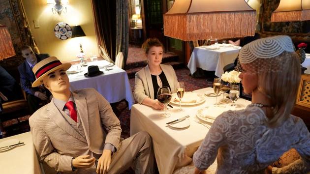 FILE PHOTO: Executive Assistant Jessie Dawson sits among mannequins occupying some tables so diners will not feel isolated by coronavirus disease (COVID-19) social distancing measures when The Inn at Little Washington, a Michelin three-star restaurant, reopens shortly in Washington, Virginia, U.S., May 20, 2020. REUTERS/Kevin Lamarque/File Photo (REUTERS)