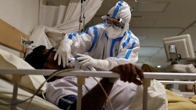 A medical worker in personal protective equipment (PPE) takes care of a patient suffering from the coronavirus disease (COVID-19), in the Intensive Care Unit (ICU) of the Max Smart Super Speciality Hospital in New Delhi on May 28. While India eases a more than two-month long lockdown aimed at reining in the spread of the disease, the battle against the virus rages within its hospital system. (Danish Siddiqui / REUTERS)