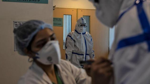 A medical worker writes the name of a colleague on his PPE as they prepare to enter the Covid-19 ward at Max Smart Super Speciality Hospital. India has recorded almost 191,000 cases and a little over 5,400 deaths due to the disease as of early June 1 according to the covid19india.org and worldometers coronavirus trackers. (Danish Siddiqui / REUTERS)