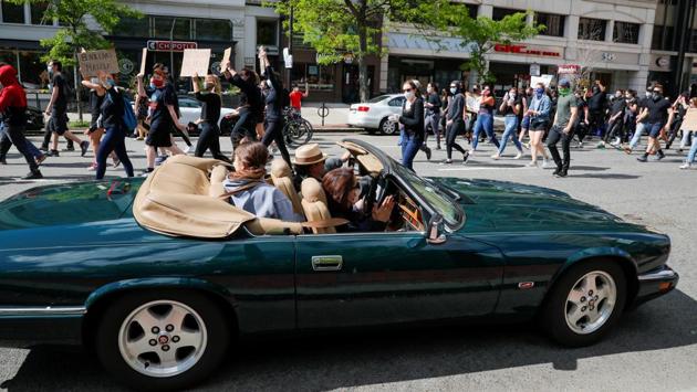 A car passes by protesters at a rally in Boston, Massachusetts, on May 31. What began as peaceful demonstrations over the death of Floyd, who died as a white Minneapolis police officer knelt on his neck, have become a wave of outrage sweeping a politically and racially divided nation. (Brian Snyder / REUTERS)