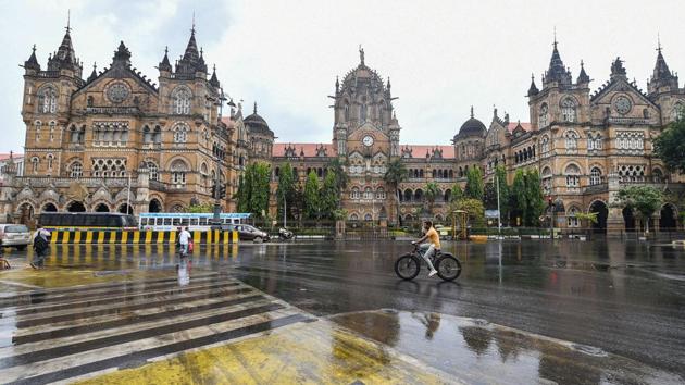 A man cycles in front of Chhatrapati Shivaji Maharaj Terminus amid rains in Mumbai, on Monday. (PTI File Photo) A man cycles in front of Chhatrapati Shivaji Maharaj Terminus amid rains in Mumbai, on Monday. (PTI File Photo)