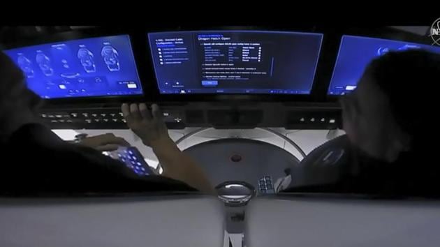 NASA astronauts Douglas Hurley and Robert Behnken on-board SpaceX’s Crew Dragon spacecraft before the hatch opened to the International Space Station on May 31. Behnken said he and Hurley were able to get a few hours of sleep during their 19-hour orbital journey, telling the administrator that “the first night is always a little bit of a challenge, but the Dragon is a slick vehicle and we had good airflow so we had an excellent evening,” reported Reuters. (NASA TV / AFP)
