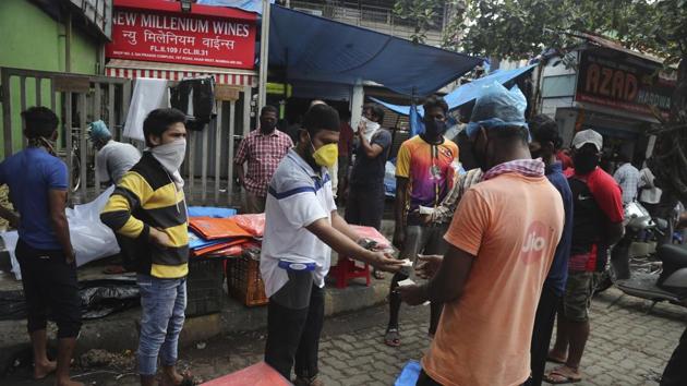 People buy tarpaulin from a roadside vendor in Mumbai, on Monday. More states opened up and crowds of commuters trickled onto the roads in many of the cities on June 1. (AP Photo) People buy tarpaulin from a roadside vendor in Mumbai, on Monday. More states opened up and crowds of commuters trickled onto the roads in many of the cities on June 1. (AP Photo)