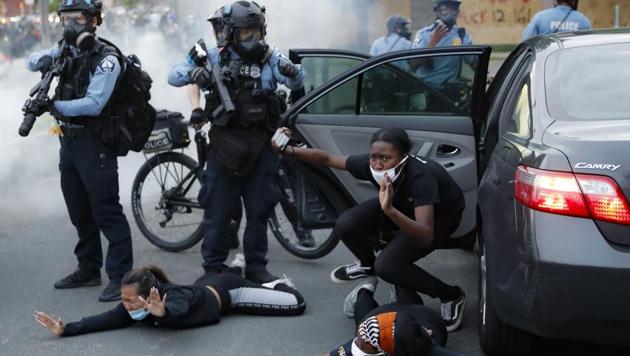 Motorists are ordered to the ground from their vehicle by the police during a protest at South Washington Street, Minneapolis. Protests across the U.S. continued following the death of George Floyd, who died after being restrained by Minneapolis police officers on Memorial Day. (John Minchillo / AP)